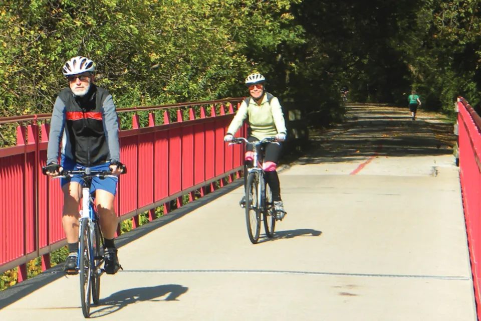 People riding bike son paved greenway in Indianapolis, Indiana.